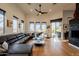 Spacious living room featuring a sectional sofa, fireplace, and hardwood floors at 12026 N 138Th St, Scottsdale, AZ 85259