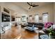 Open living room with sectional sofa, hardwood floors, and views into dining area at 12026 N 138Th St, Scottsdale, AZ 85259