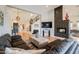 Living room with sectional sofa, hardwood floors, fireplace and a view to the entryway at 12026 N 138Th St, Scottsdale, AZ 85259