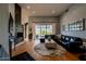 Living room with sectional sofa, hardwood floors, fireplace, and sliding glass doors at 12026 N 138Th St, Scottsdale, AZ 85259