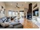 Spacious living room featuring a sectional sofa, fireplace, and hardwood floors at 12026 N 138Th St, Scottsdale, AZ 85259