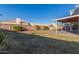 Spacious backyard with grassy lawn, covered patio, and block wall at 1220 W Gail Ct, Chandler, AZ 85224