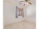 Bright bedroom featuring ceiling fan and tile floors at 1220 W Gail Ct, Chandler, AZ 85224