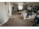 Large living room with carpeted floors and built-in shelving at 12321 W Florence St, Avondale, AZ 85323