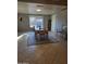 Bright dining area with a wood table and chairs, tiled floors and a view to backyard at 12411 N Cantata Ct, Sun City, AZ 85351