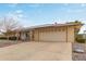 Ranch-style home with solar panels and a two-car garage at 12411 N Cantata Ct, Sun City, AZ 85351