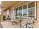 Relaxing front porch with striped chairs and small table at 12411 N Cantata Ct, Sun City, AZ 85351