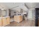 Kitchen with wood cabinets, island, and stainless steel appliances at 12411 N Cantata Ct, Sun City, AZ 85351