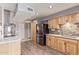 Kitchen with wood cabinets, a stone backsplash, and stainless steel appliances at 12411 N Cantata Ct, Sun City, AZ 85351