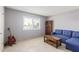 Relaxing living room with a blue couch and guitar at 12411 N Cantata Ct, Sun City, AZ 85351