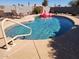 Private backyard with a sparkling in-ground pool and a pink flamingo float. Lounge and relax under the sun at 12411 N Cantata Ct, Sun City, AZ 85351