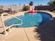 Private backyard with a sparkling in-ground pool and a pink flamingo float. Lounge and relax under the sun at 12411 N Cantata Ct, Sun City, AZ 85351