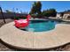 Private backyard featuring an in-ground pool with a flamingo float, ready for summer relaxation and fun at 12411 N Cantata Ct, Sun City, AZ 85351