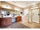 Accessible bathroom with double sinks, glass shower, and a walk-in tub at 13129 W Junipero Dr, Sun City West, AZ 85375