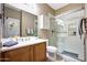 Bathroom with single vanity, glass shower, and neutral color scheme at 13129 W Junipero Dr, Sun City West, AZ 85375