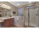 Bathroom with walk-in shower, soaking tub, and updated fixtures at 13129 W Junipero Dr, Sun City West, AZ 85375