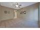 Bright and airy bedroom with ceiling fan and neutral decor at 13129 W Junipero Dr, Sun City West, AZ 85375