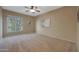 Well-lit bedroom with large window, ceiling fan, and neutral tones at 13129 W Junipero Dr, Sun City West, AZ 85375