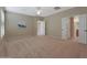 Spacious bedroom with neutral carpeting and access to bathroom at 13129 W Junipero Dr, Sun City West, AZ 85375