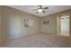 Spacious bedroom with ceiling fan, neutral wall colors, and natural light at 13129 W Junipero Dr, Sun City West, AZ 85375