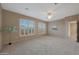 Bright bedroom with ceiling fan and neutral carpeting at 13129 W Junipero Dr, Sun City West, AZ 85375