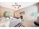 Another view of cozy bedroom with ceiling fan, neutral decor and closet at 13129 W Junipero Dr, Sun City West, AZ 85375