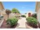 Private courtyard with stone table, bench, and lush landscaping, offering a serene outdoor space at 13129 W Junipero Dr, Sun City West, AZ 85375