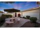 Outdoor patio area with seating and a shaded umbrella at 13129 W Junipero Dr, Sun City West, AZ 85375