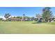 Driving range and clubhouse with golf carts at 13129 W Junipero Dr, Sun City West, AZ 85375