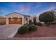 Single-story home with a two-car garage and landscaped front yard at 13129 W Junipero Dr, Sun City West, AZ 85375