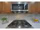 Gas cooktop with stainless steel microwave above at 13129 W Junipero Dr, Sun City West, AZ 85375