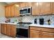 Updated kitchen featuring stainless steel appliances, modern backsplash, and ample cabinet space at 13129 W Junipero Dr, Sun City West, AZ 85375