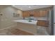 Modern kitchen with stainless steel appliances and white countertops at 13129 W Junipero Dr, Sun City West, AZ 85375