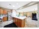 Open kitchen with a central island, stainless steel fridge, and easy flow to the living area at 13129 W Junipero Dr, Sun City West, AZ 85375
