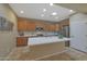 Modern kitchen with wood cabinets and a large kitchen island at 13129 W Junipero Dr, Sun City West, AZ 85375