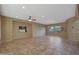 Spacious living room with tile floors and large windows at 13129 W Junipero Dr, Sun City West, AZ 85375