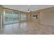 Bright living room with tile floors and ceiling fan at 13129 W Junipero Dr, Sun City West, AZ 85375