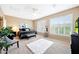 Bright main bedroom with neutral colors, plantation shutters, and a plush rug at 13129 W Junipero Dr, Sun City West, AZ 85375