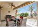 Covered patio with outdoor dining set and view of the well-maintained backyard at 13129 W Junipero Dr, Sun City West, AZ 85375