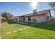 Large backyard with grassy lawn and house view at 1354 E Brentrup Dr, Tempe, AZ 85283