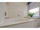 Relaxing bathroom with a large, oval-shaped bathtub and window at 1354 E Brentrup Dr, Tempe, AZ 85283