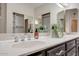 Modern bathroom with double vanity and dark brown cabinets at 1354 E Brentrup Dr, Tempe, AZ 85283