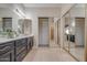 Bathroom featuring double vanity and mirrored closet doors at 1354 E Brentrup Dr, Tempe, AZ 85283