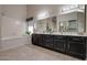 Bathroom with double vanity, large mirror, and a bathtub at 1354 E Brentrup Dr, Tempe, AZ 85283