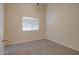 Simple bedroom with neutral walls and carpeted floor at 1354 E Brentrup Dr, Tempe, AZ 85283