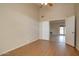 Bedroom with wood-look flooring and access to another room at 1354 E Brentrup Dr, Tempe, AZ 85283