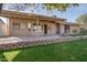 Back of house with covered patio and landscaped yard at 1354 E Brentrup Dr, Tempe, AZ 85283