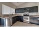 Modern kitchen with dark cabinetry, stainless steel appliances and granite countertops at 1354 E Brentrup Dr, Tempe, AZ 85283