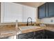 Kitchen features a double sink, granite countertops, and dark wood cabinets at 1354 E Brentrup Dr, Tempe, AZ 85283