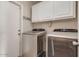 Laundry room with washer, dryer, and overhead cabinets at 1354 E Brentrup Dr, Tempe, AZ 85283